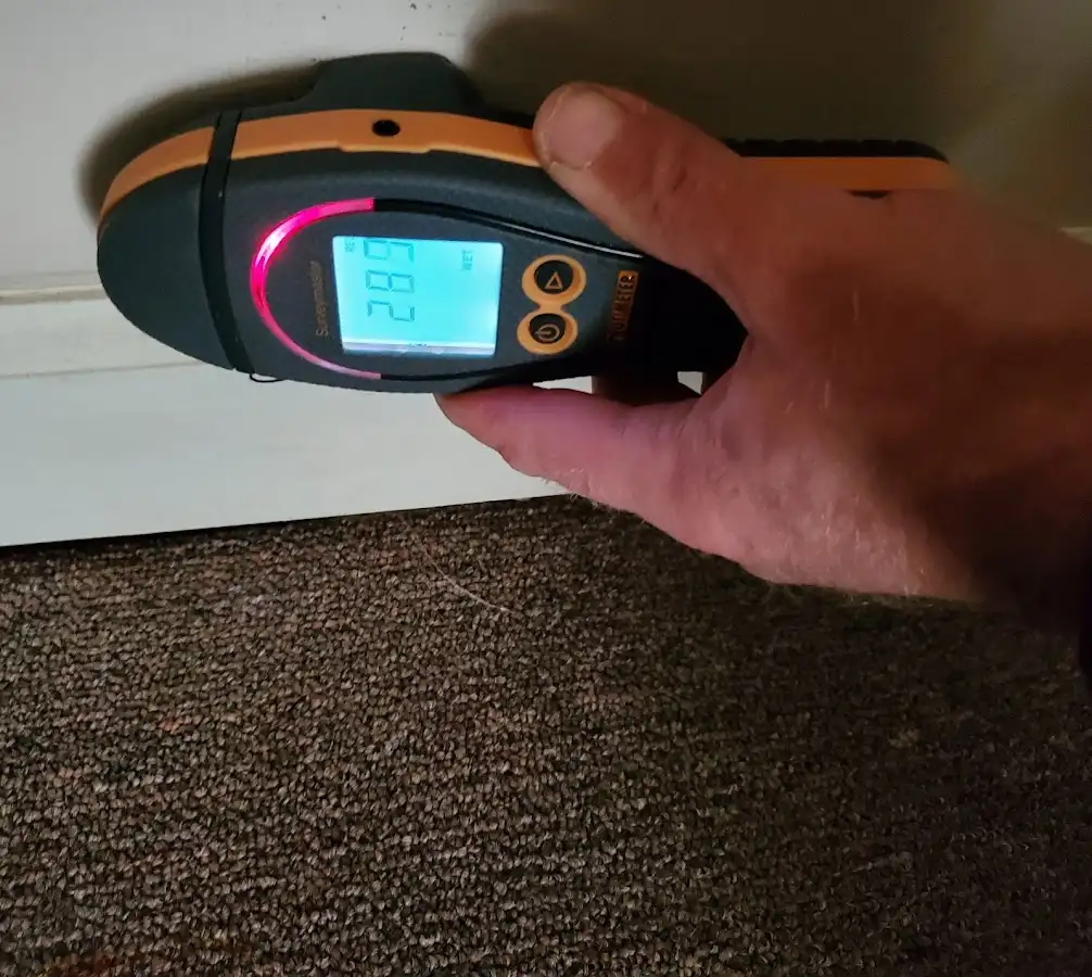 Moisture detection at baseboard during Burst Pipe Cleanup in College